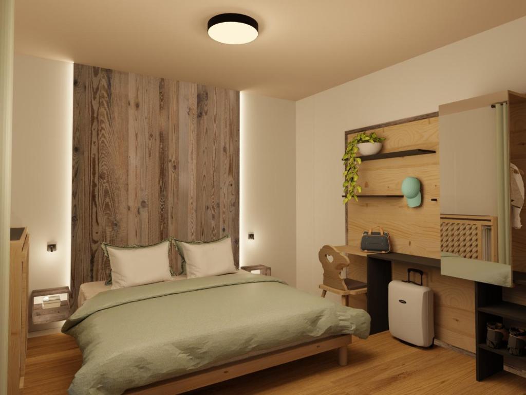 Postel nebo postele na pokoji v ubytování Hotel Dolomiti Des Alpes