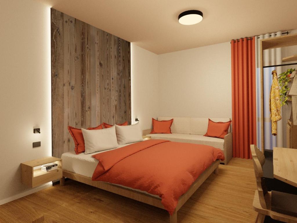 Postel nebo postele na pokoji v ubytování Hotel Dolomiti Des Alpes