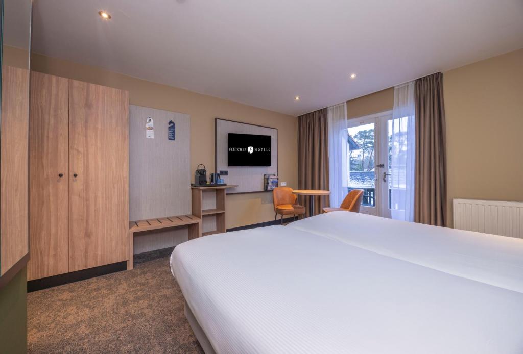 TV a/nebo společenská místnost v ubytování Fletcher Hotel-Restaurant Klein Zwitserland
