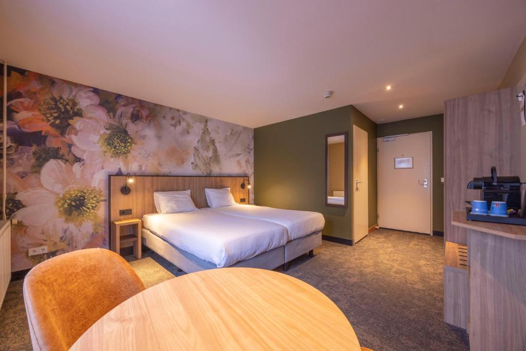Postel nebo postele na pokoji v ubytování Fletcher Hotel-Restaurant Klein Zwitserland