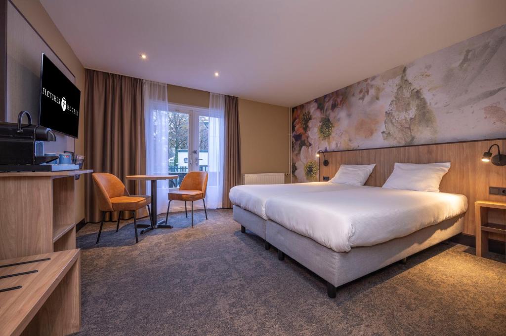 Postel nebo postele na pokoji v ubytování Fletcher Hotel-Restaurant Klein Zwitserland