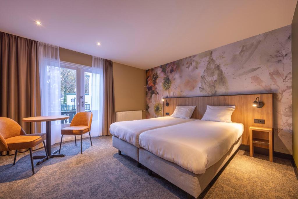 Postel nebo postele na pokoji v ubytování Fletcher Hotel-Restaurant Klein Zwitserland