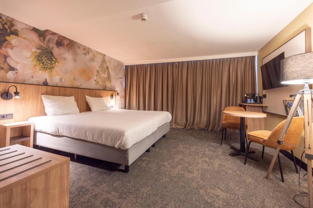 Postel nebo postele na pokoji v ubytování Fletcher Hotel-Restaurant Klein Zwitserland