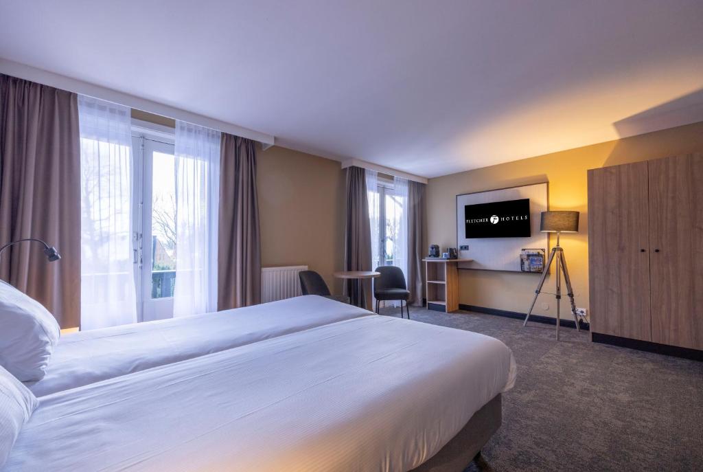 TV a/nebo společenská místnost v ubytování Fletcher Hotel-Restaurant Klein Zwitserland