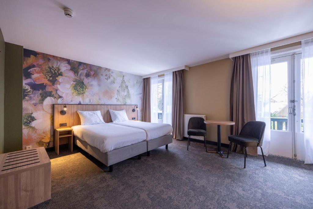 Postel nebo postele na pokoji v ubytování Fletcher Hotel-Restaurant Klein Zwitserland