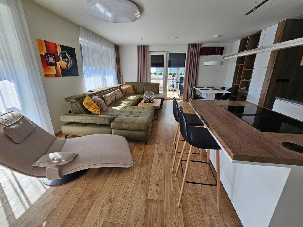 a living room with a couch and a table at Moderný apartmán s terasou in Prievidza
