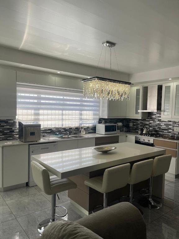 a kitchen with a table and chairs and a chandelier at Giftly Surprize in Kimberley