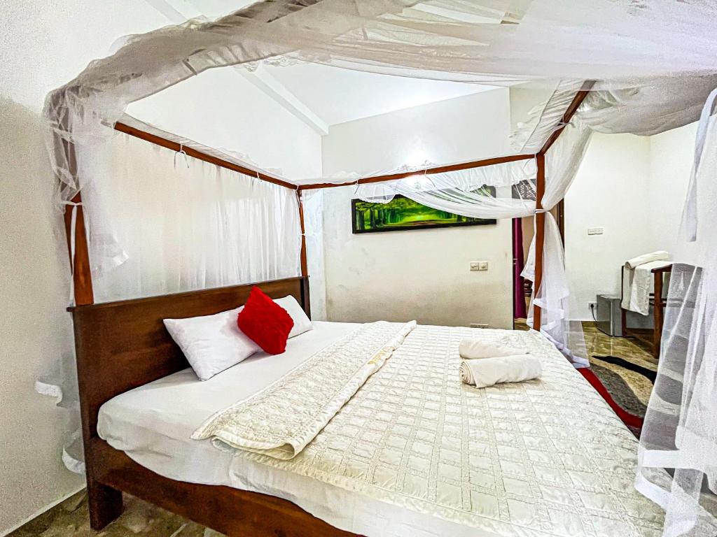 Postel nebo postele na pokoji v ubytování Galle Camellia