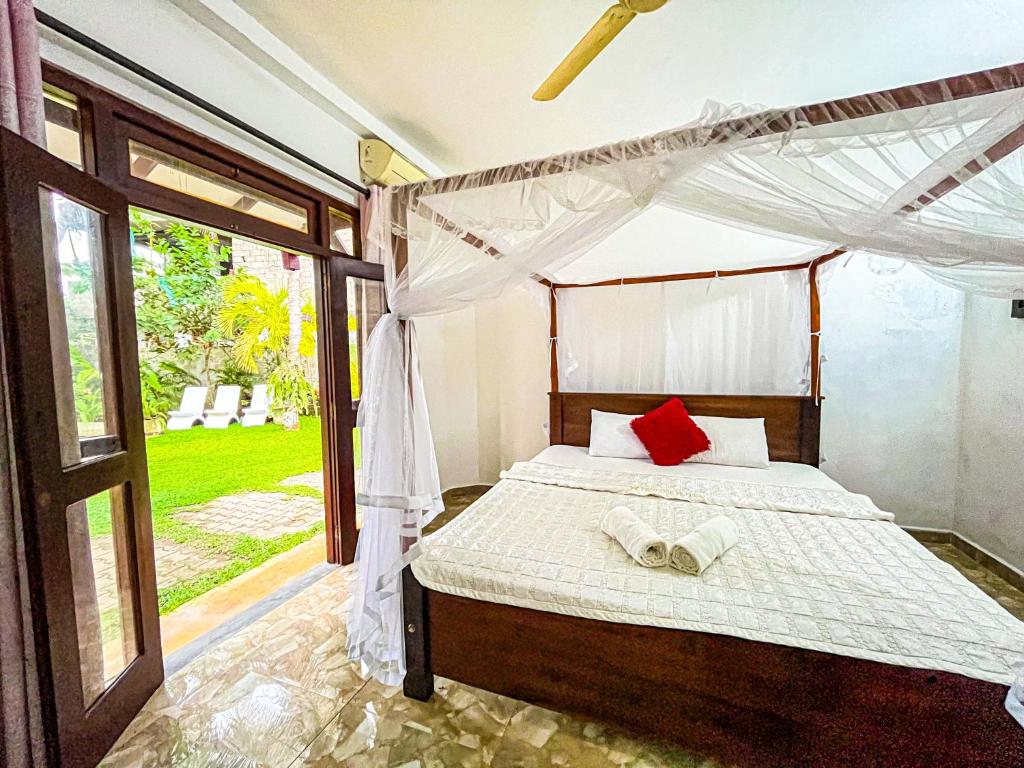 Postel nebo postele na pokoji v ubytování Galle Camellia