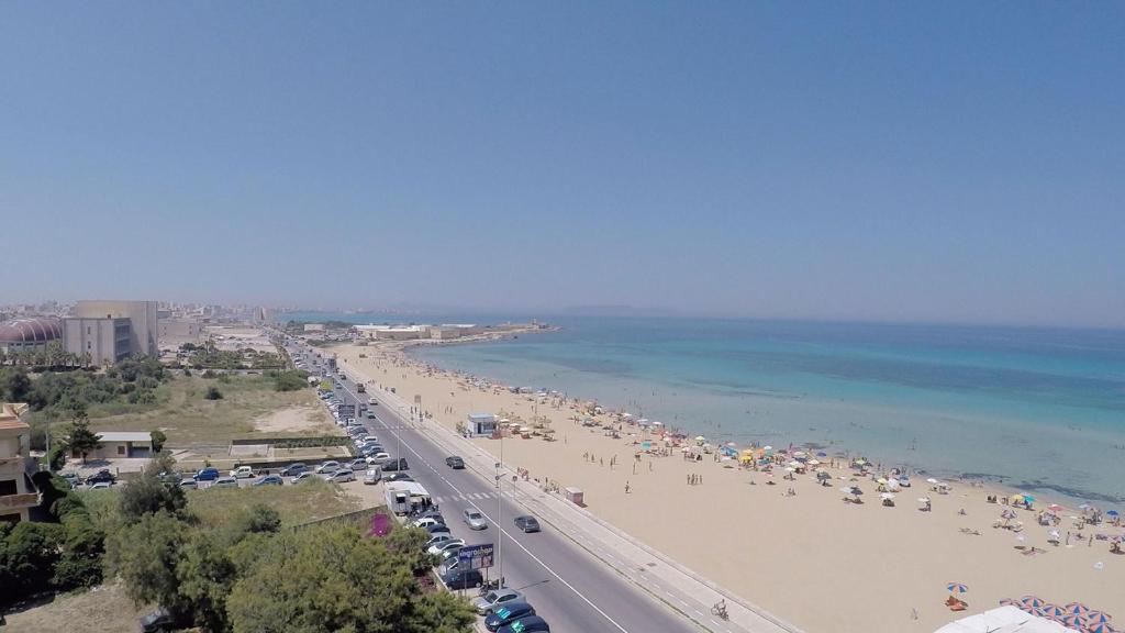 a view of a beach with people and the ocean at Appartamento presso Residence Erice Beach - Casa Vacanza in Erice