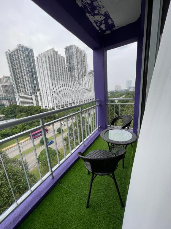 a balcony with a table and chairs and a view of a city at NR Cyber1 Homestay in Cyberjaya