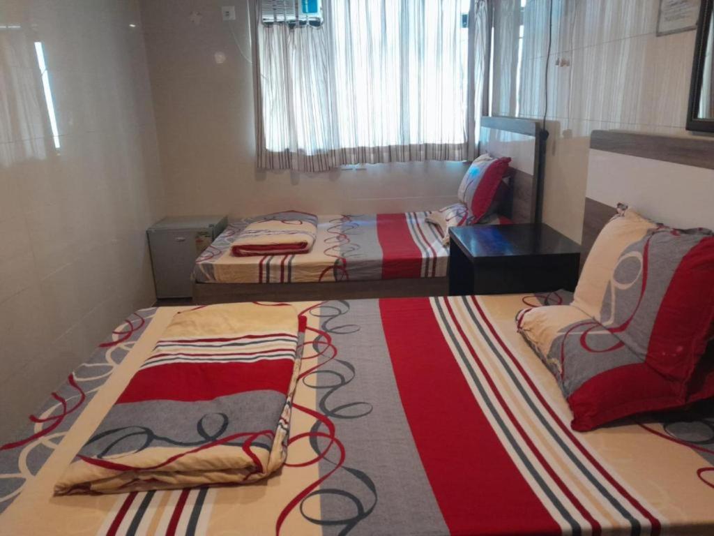 Łóżko lub łóżka w pokoju w obiekcie Golden Gate Guest House