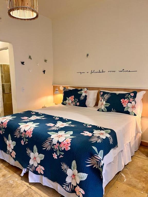 a bedroom with a bed with a blue and white blanket at Flat's Maravista Beiramar in São Miguel do Gostoso