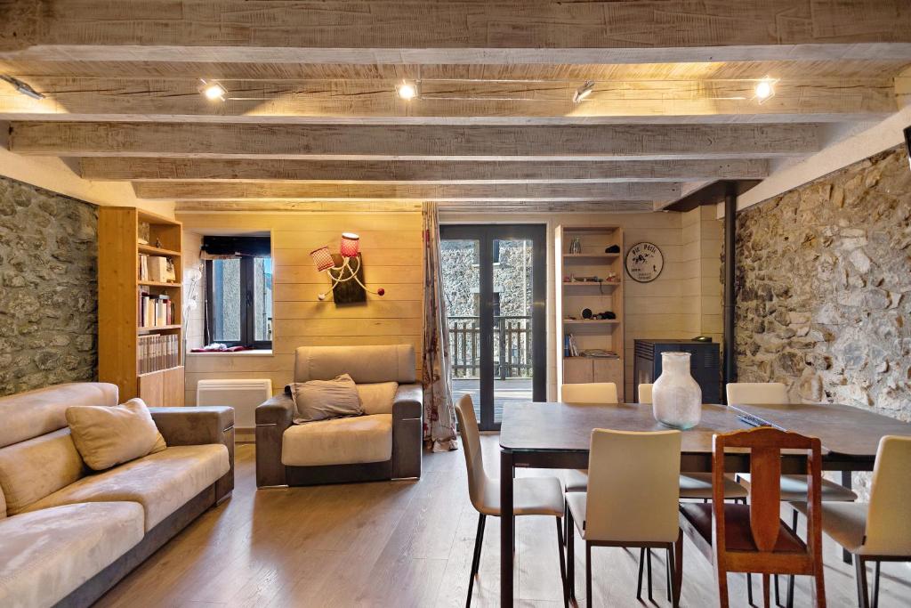 a living room with a table and a couch at Maison de village Ramballade in Les Angles