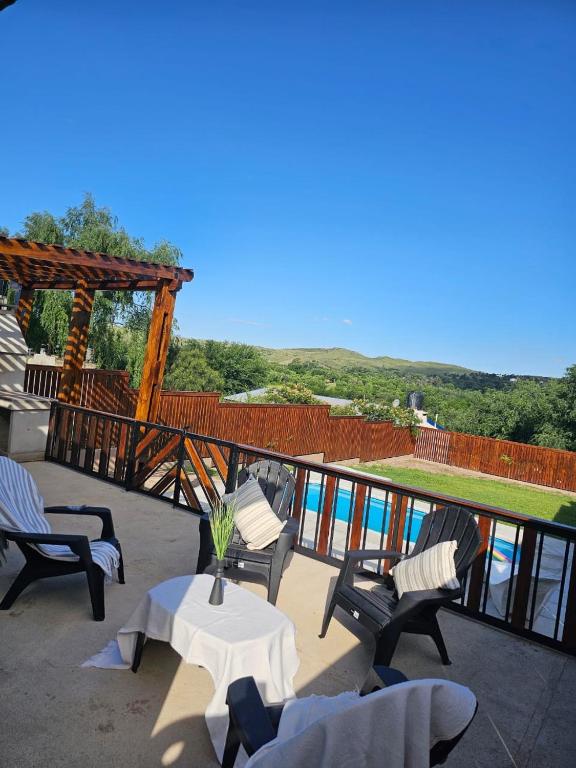 a patio with chairs and a table with a view of the water at Casa Montana in Potrero de Garay