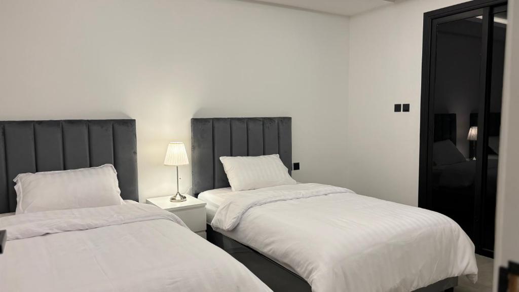 two beds sitting next to each other in a room at شقة فاخرة ومميزة في حي الملقا - luxury premium apartment in Al Malaga in Riyadh