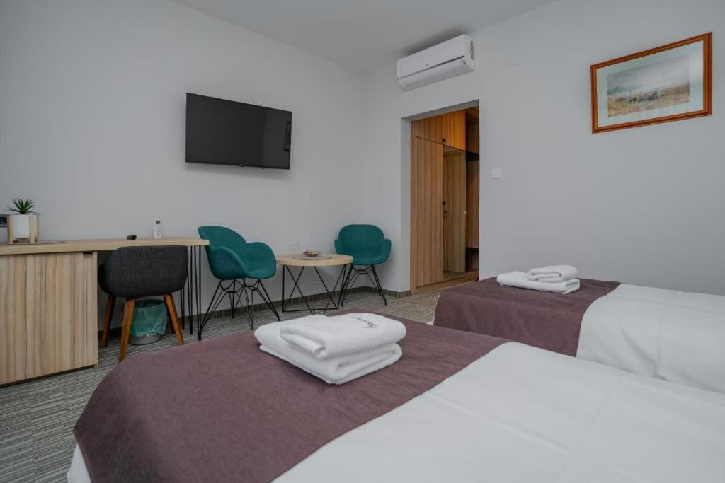 Postel nebo postele na pokoji v ubytování Maestro - Rooms & Restaurant
