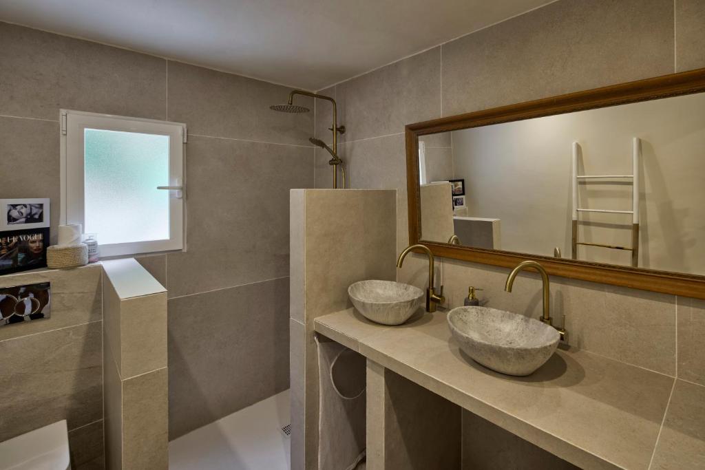 two sinks in a bathroom with a large mirror at Casa El Sueño in Jávea