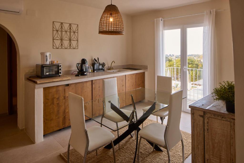 a kitchen with a table and chairs and a balcony at Casa El Sueño in Jávea