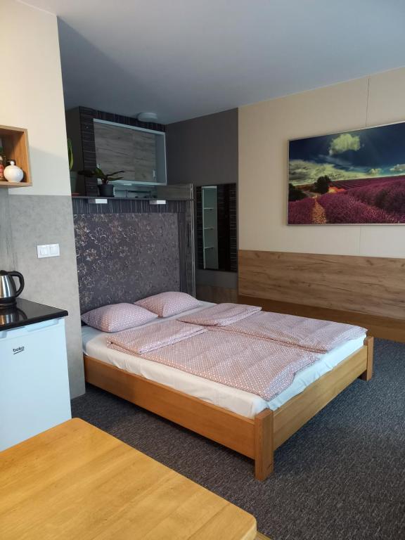 a bedroom with a bed with pink pillows on it at Apartamenty JAGA parking, FVAT in Kielce