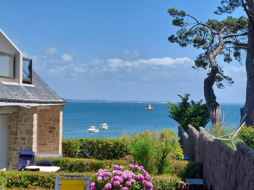 a view of the ocean from a house at Appartement Reve Marin in Saint-Pierre-Quiberon