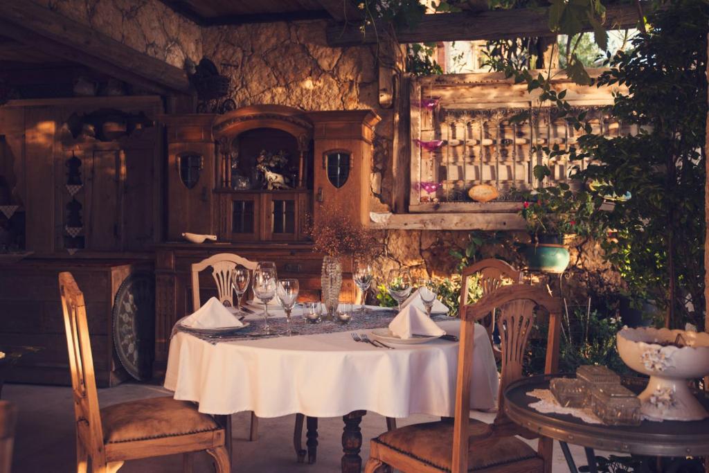 a dining room with a white table and chairs at Fidanka Hotel in Kalkan