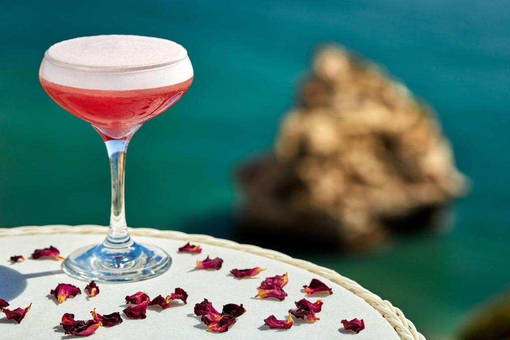 a glass of wine sitting on top of a cake at Tivoli Carvoeiro in Carvoeiro