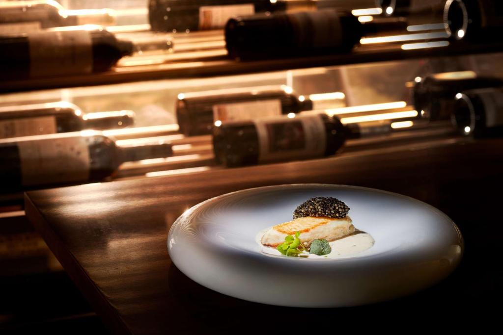 a white plate with a piece of food on a counter at Tivoli Carvoeiro in Carvoeiro