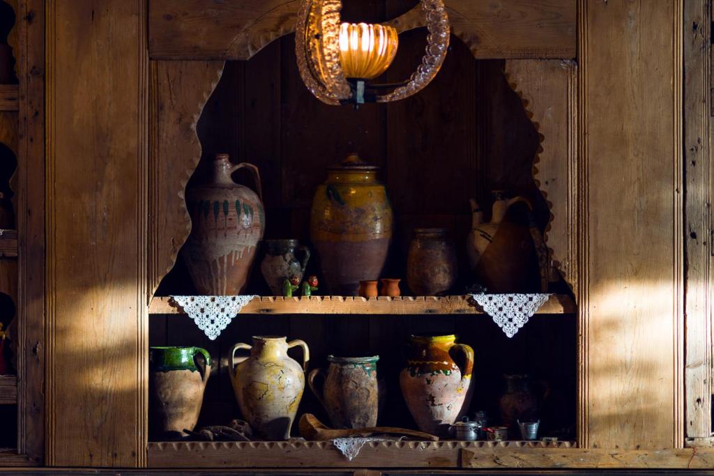 a shelf with vases and other pottery on it at Fidanka Hotel in Kalkan