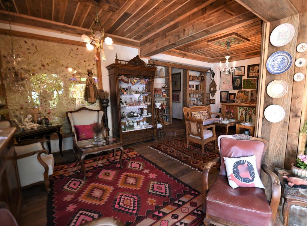 a living room filled with furniture and a room with a rug at Fidanka Hotel in Kalkan