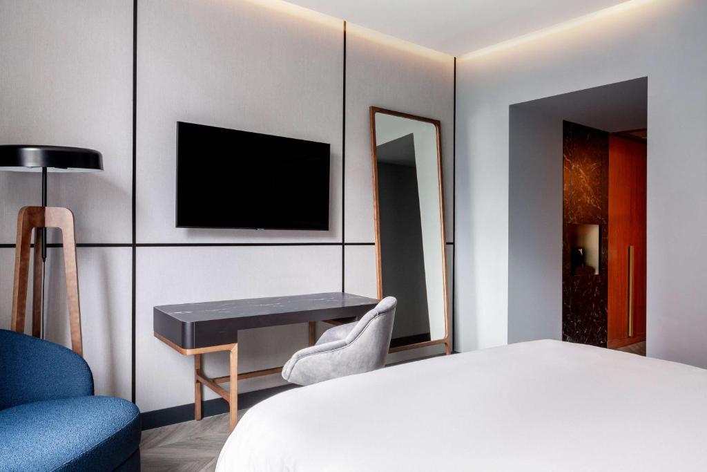 A bed or beds in a room at Radisson Collection Bilbao