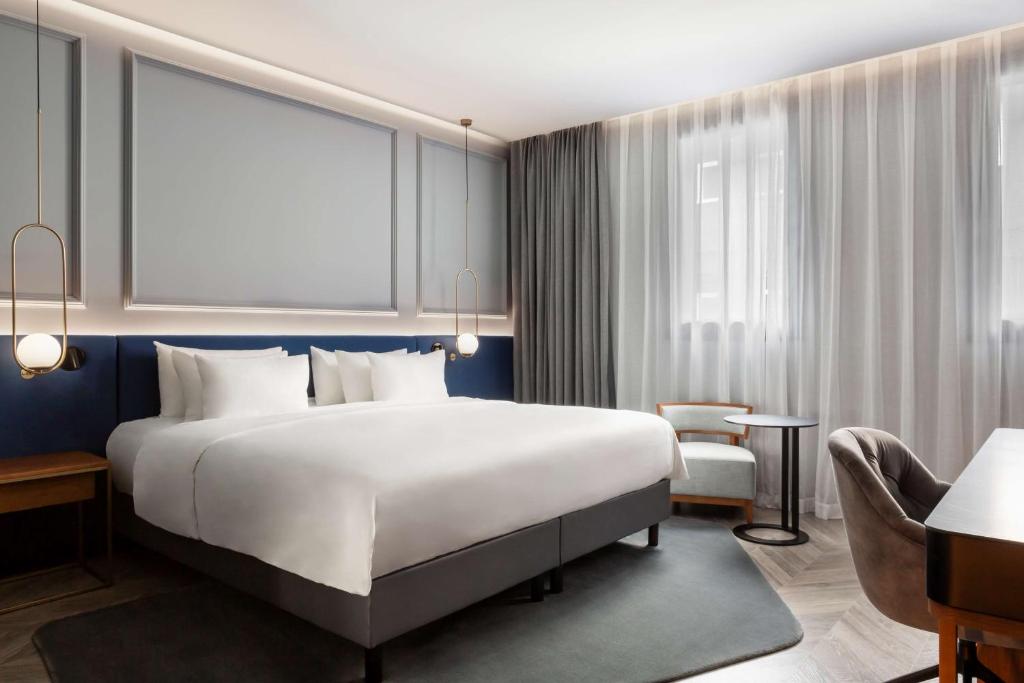 A bed or beds in a room at Radisson Collection Bilbao