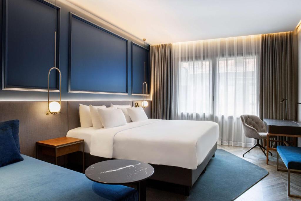 A bed or beds in a room at Radisson Collection Bilbao