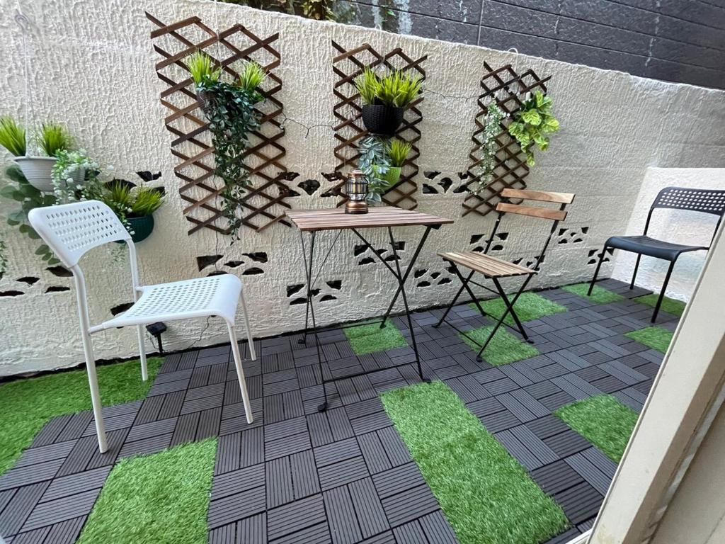 a patio with chairs and a table and a fence at Shinjuku Station 4 min by tram Higashi Nakano Station 6 min Okubo Station 10 min walk 2DK with terrace Accommodation for 5 people in Tokyo