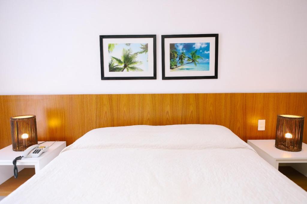 Cama ou camas em um quarto em Porto Suítes Natal Hotel