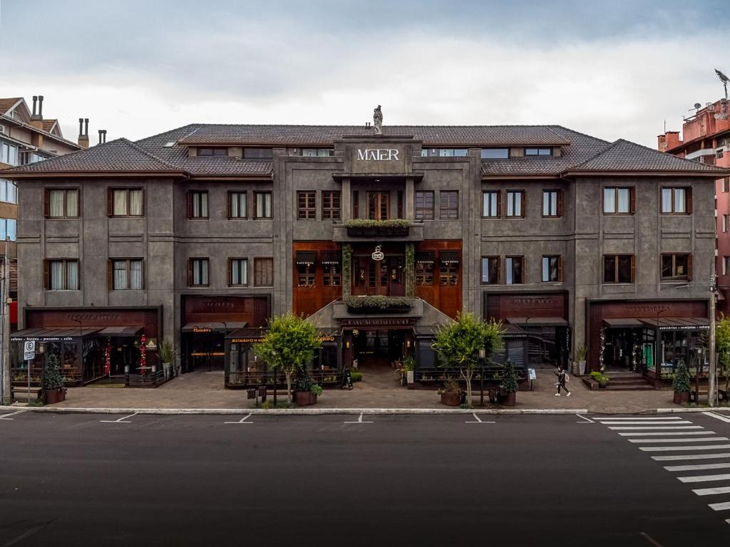 a large building on a city street with a street at Mater Hotel in Canela