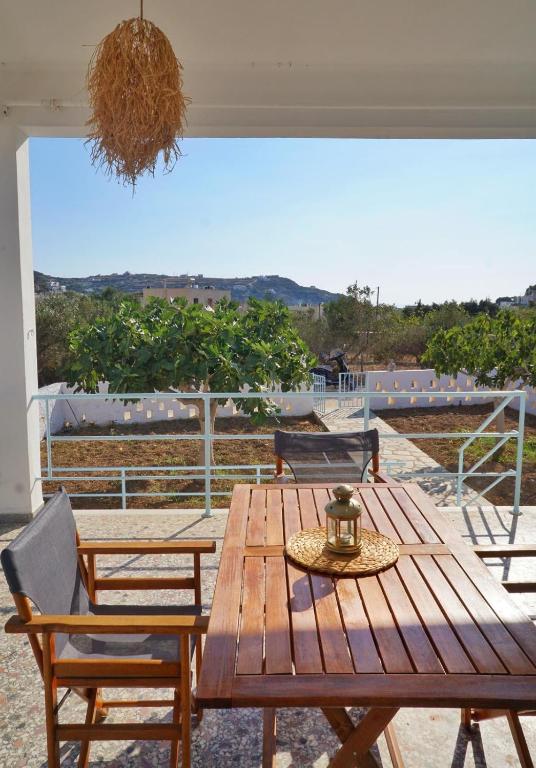 a wooden table and chairs on a patio at Michael's Home Cycladic Cottage House in Kini