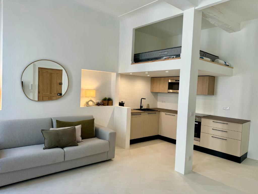 a living room with a couch and a kitchen at Studio du port - Porte marine in Antibes