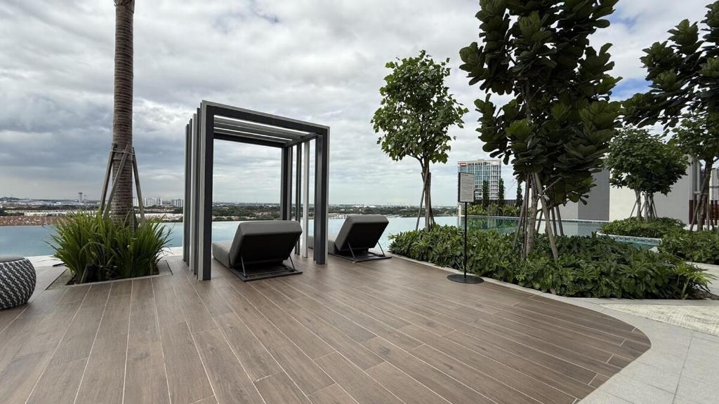 a deck with two chairs and a mirror on a building at Sunsuria Forum - Masuyo Homes in Shah Alam