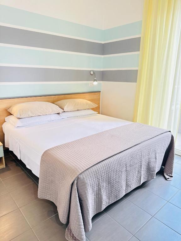 Postel nebo postele na pokoji v ubytování Hotel Villa Perazzini