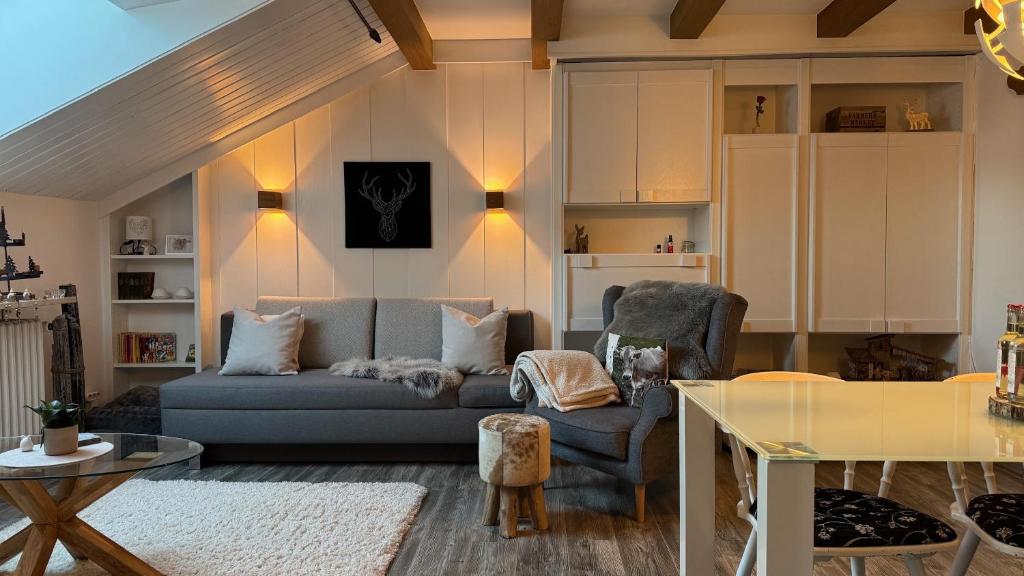a living room with a couch and a table at Ferienwohnung Alpenglück mit Schwimmbad und Sauna in Oberstdorf