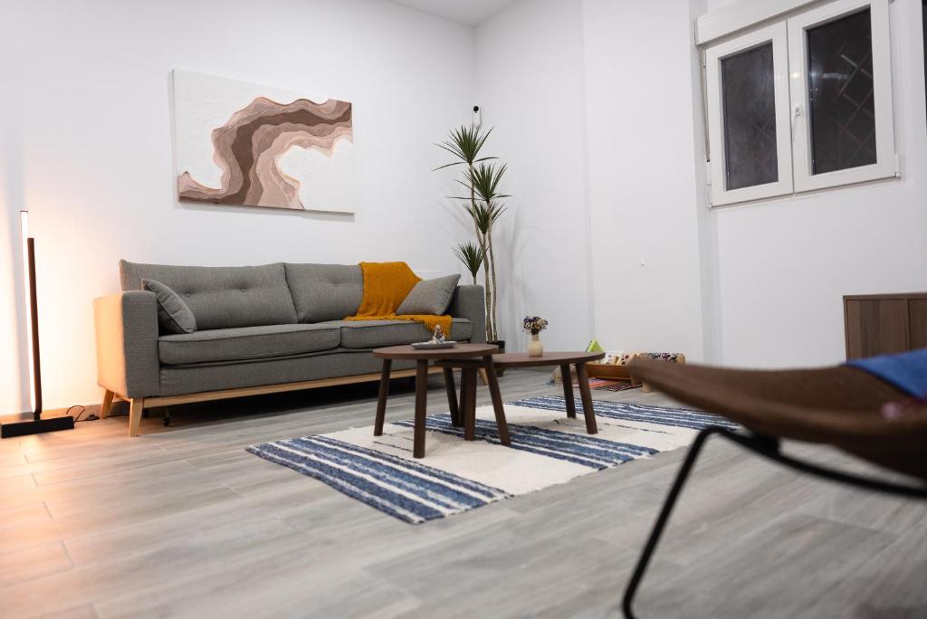 a living room with a couch and a table at Casa Lola Sanlucar de Barrameda in Sanlúcar de Barrameda