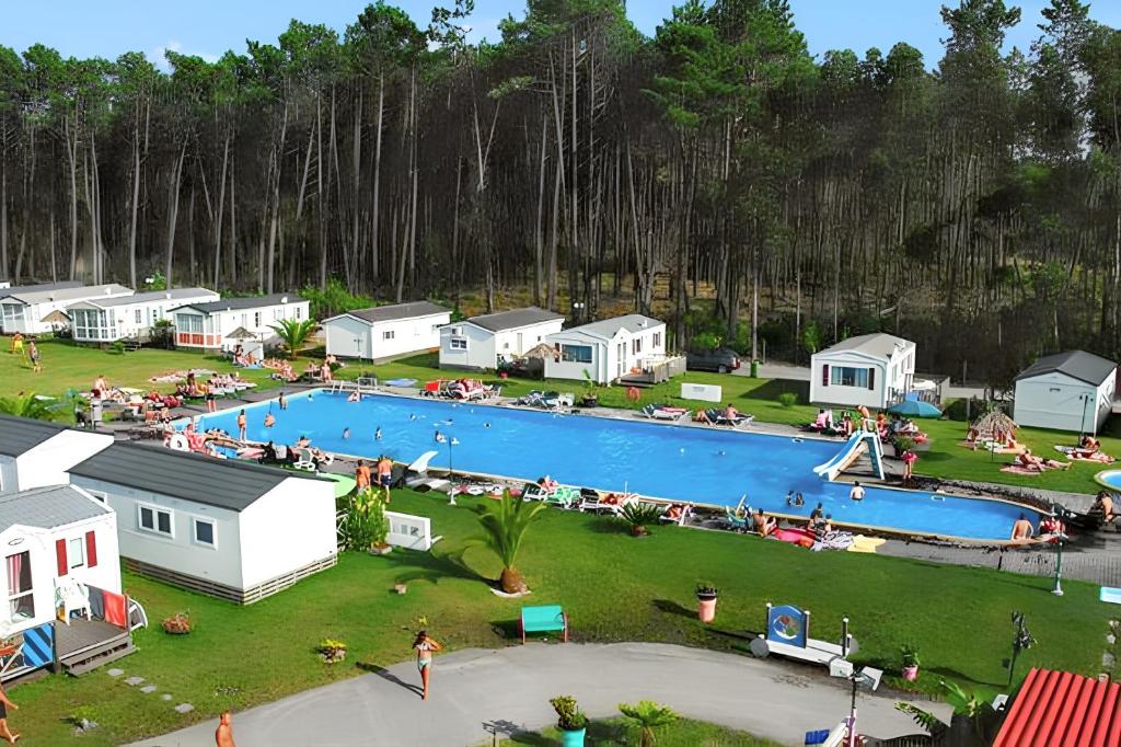 an aerial view of a large swimming pool with houses at Bungalow with Shared Pool in Pataias + 30 m² + Pool. in Pataias