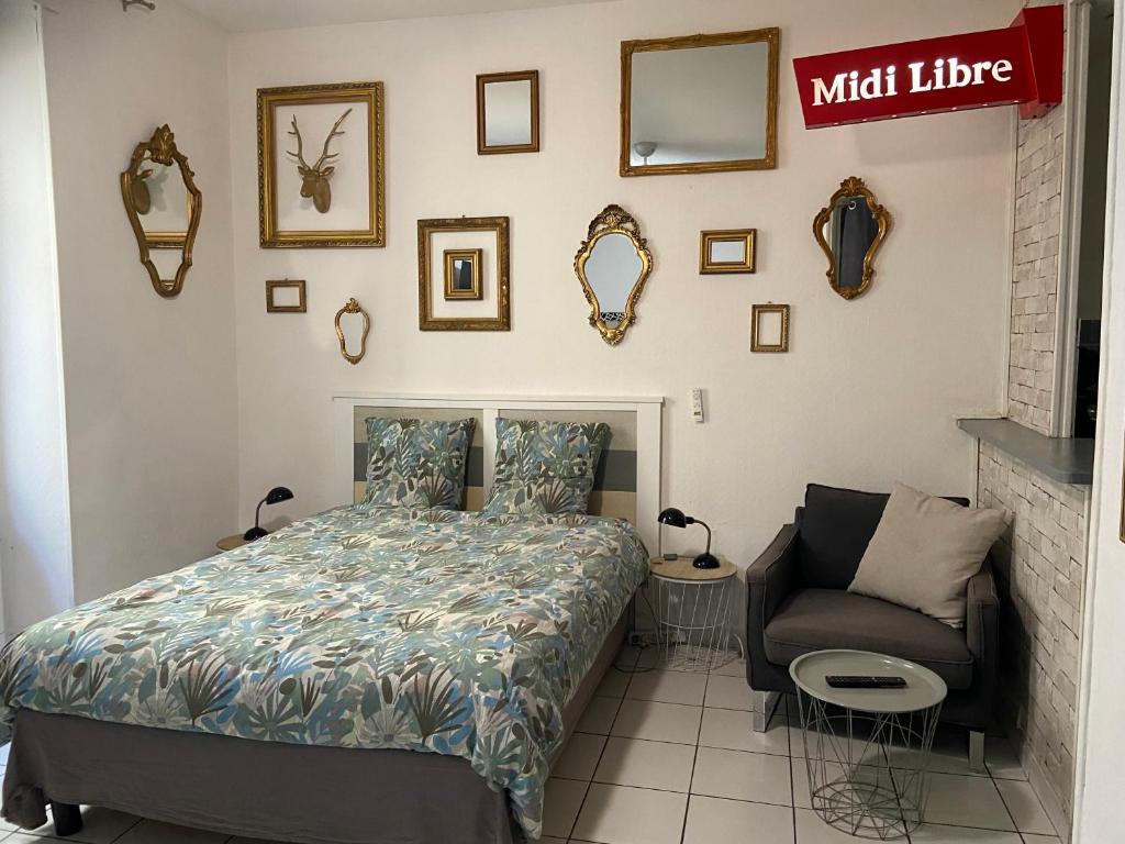 une chambre avec un lit et une chaise dans l'établissement Studio Triangle Arêne Gare Maison Carrée Placette, à Nîmes