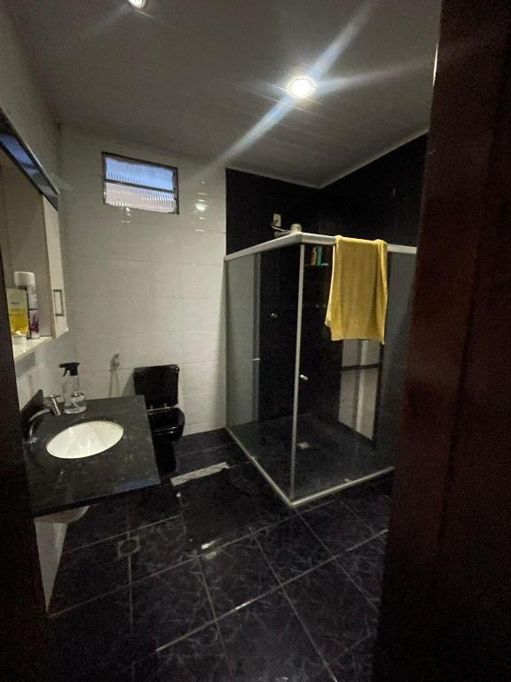 a bathroom with a sink and a shower at Casa ao ar livre in Aracaju