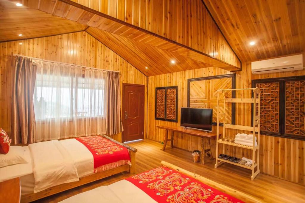 Postel nebo postele na pokoji v ubytování Long An Hotel 龙胜龙安酒店