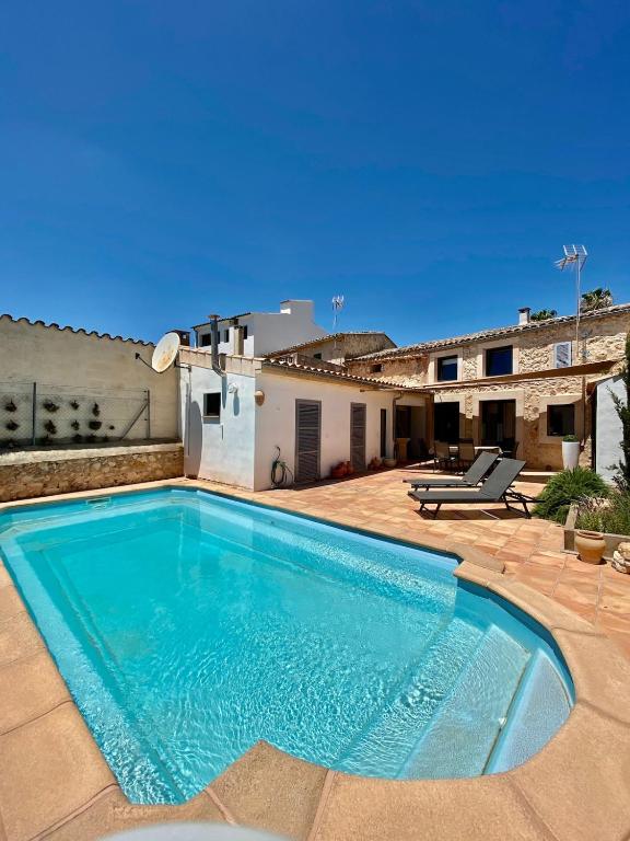 a swimming pool in front of a house at Villas2meet Jimmy Lloret in Lloret de Vistalegre