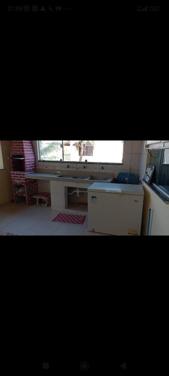 a kitchen with a counter and a window in a room at Casa Guaibim ótima localização in Valença