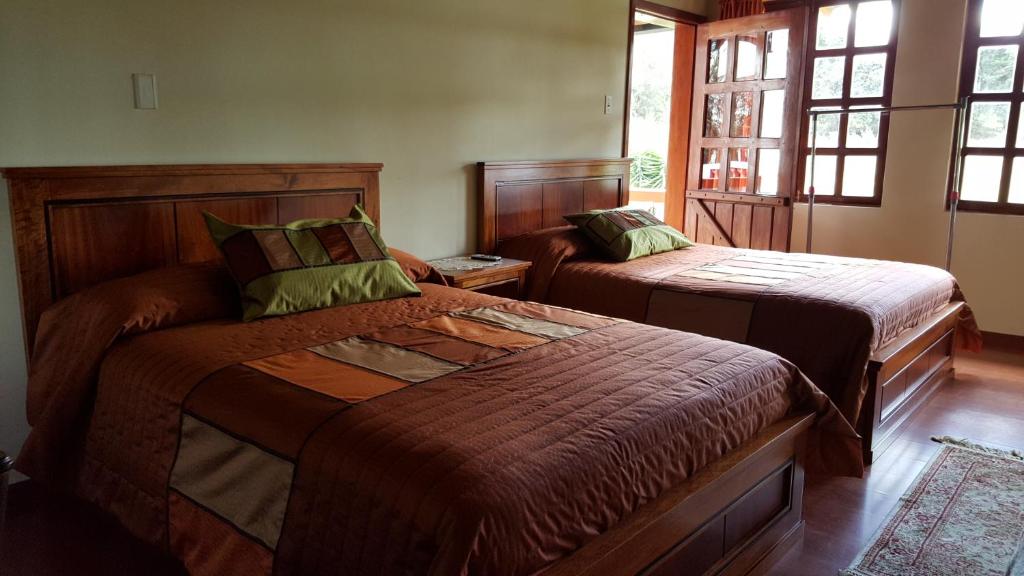 Postel nebo postele na pokoji v ubytování Hosteria San Carlos Tababela