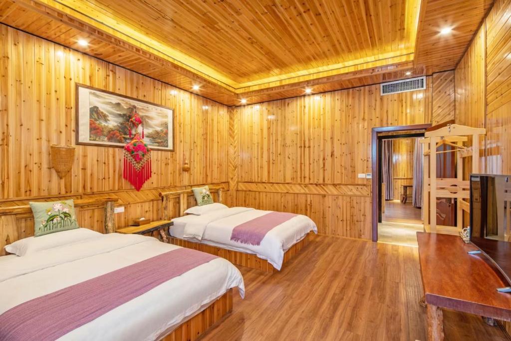 Postel nebo postele na pokoji v ubytování Long An Hotel 龙胜龙安酒店